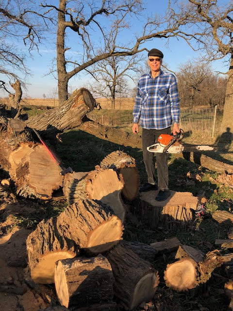 Mark with pile of oak blocks recently sliced for firelood Mark with pile of oak blocks recently sliced for firelood